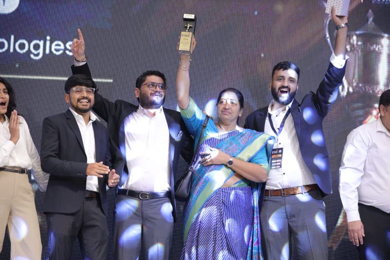 Amenity Technologies team celebrating on stage with the Best Emerging Technology Company trophy at the Saurashtra IT-ITeS Excellence Awards 2024